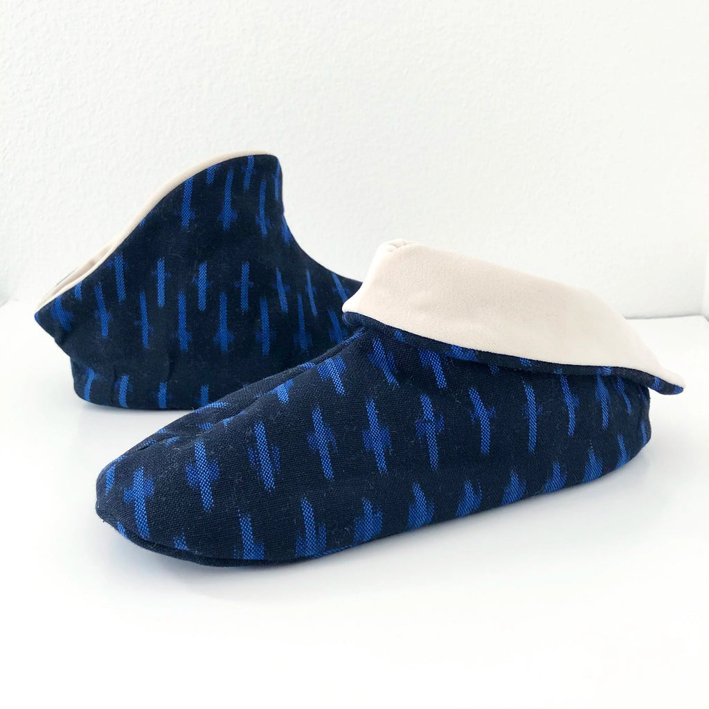 Cozy Slipper sewing pattern Pair of blue ikat slippers with white lining on a white background, front view