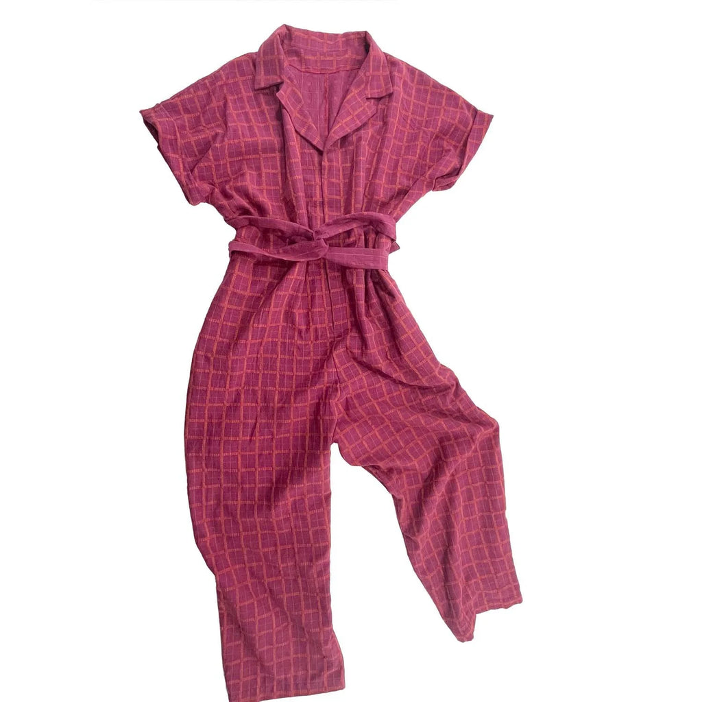 Bumper Jumper sewing pattern — flat image of loose-fit pink plaid woven jumper with side pockets, front buttons and roll-up sleeves, front view