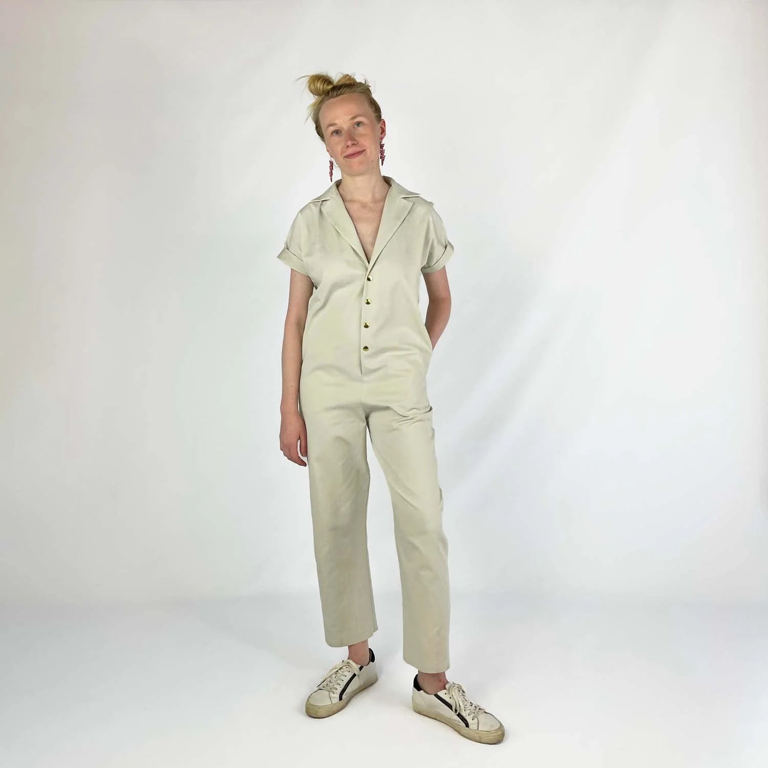 Bumper Jumper sewing pattern — woman wearing a loose-fit woven jumper with side pockets, front snaps and roll-up sleeves, second front view