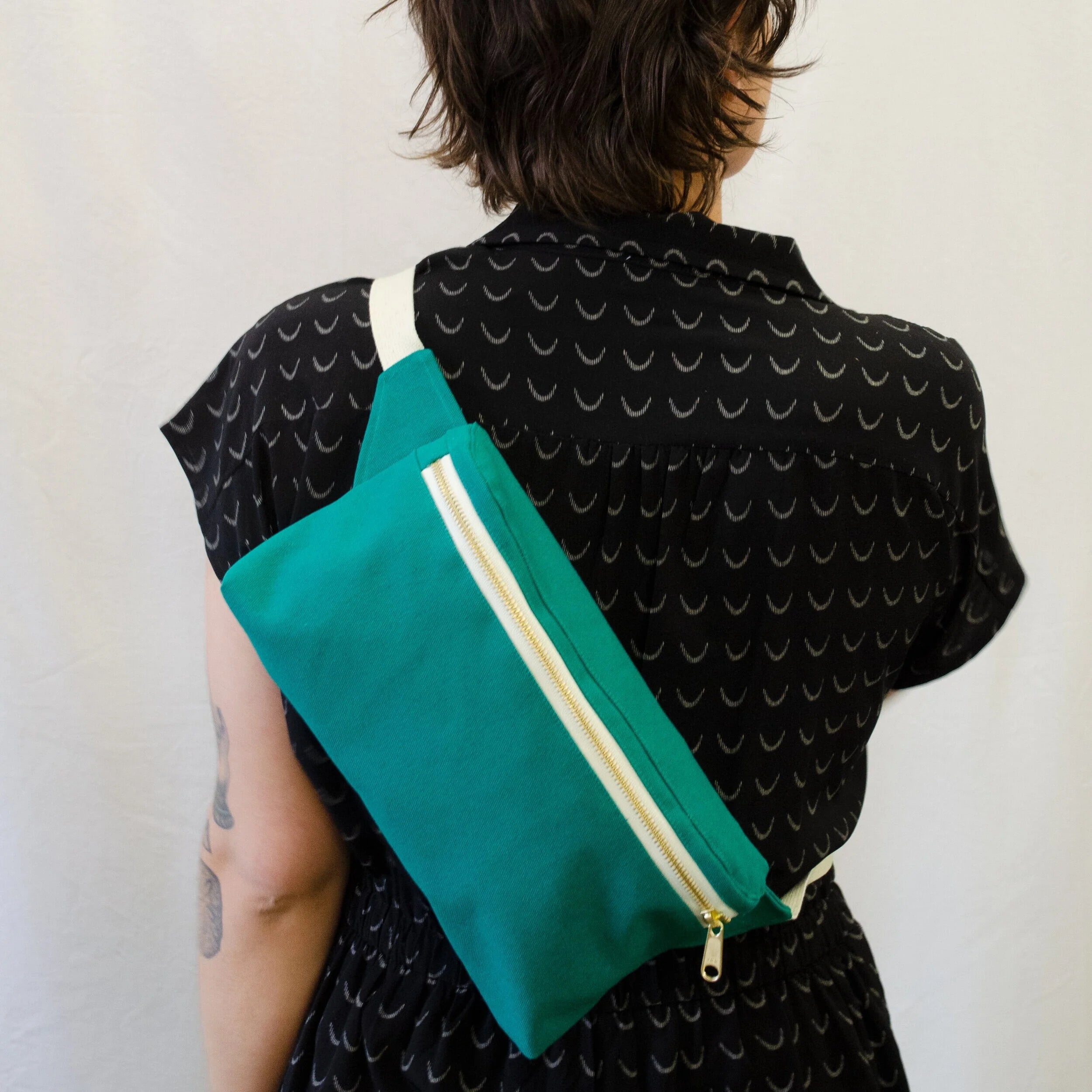 Hip Pack sewing pattern — model wearing large green over the cross body bag across back