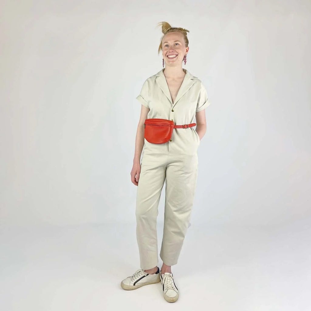 Bumper Bundle sewing pattern —Person wearing a beige outfit with a red belt bag on a white background