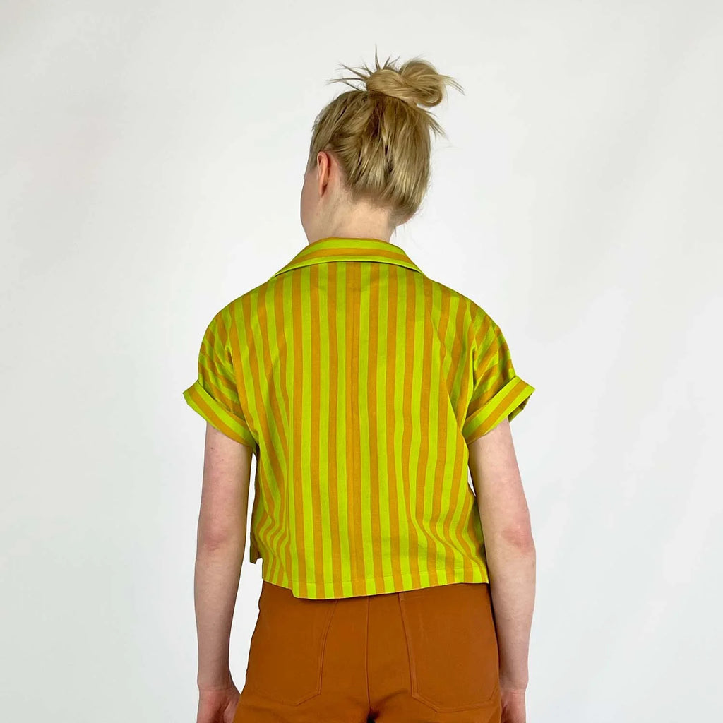 Bumper Bundle sewing pattern — Person wearing a yellow and green striped short sleeved shirt with rolled cuffs against a white background - back view