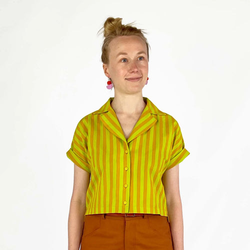 Bumper Bundle sewing pattern — Person wearing a yellow and green striped short sleeved shirt with rolled cuffs against a white background - second front view