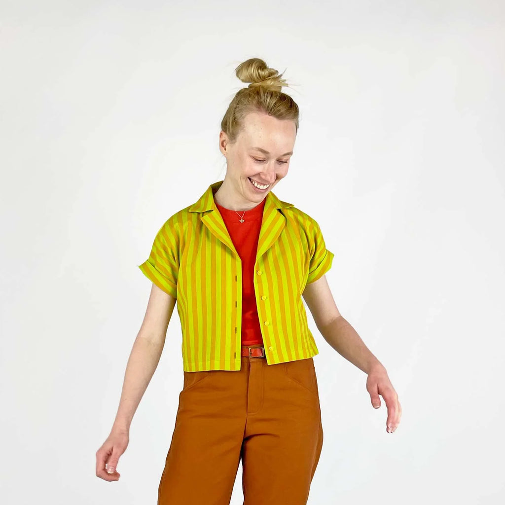 Bumper Bundle sewing pattern — Person wearing a yellow and green striped short sleeved shirt with rolled cuffs against a white background - shirt opened view