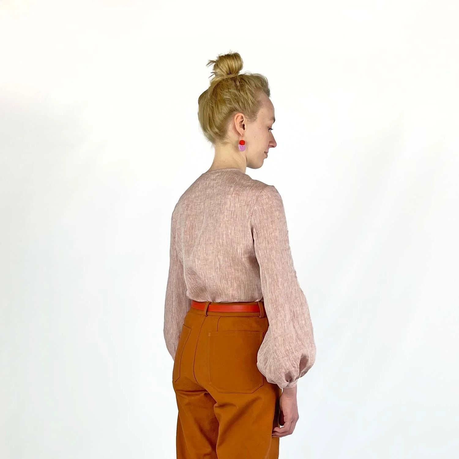 Gable Shirt sewing pattern — model wearing a button-front blouse in a grid paper patterned fabric with long sleeves sleeves and collarless neckline, back view