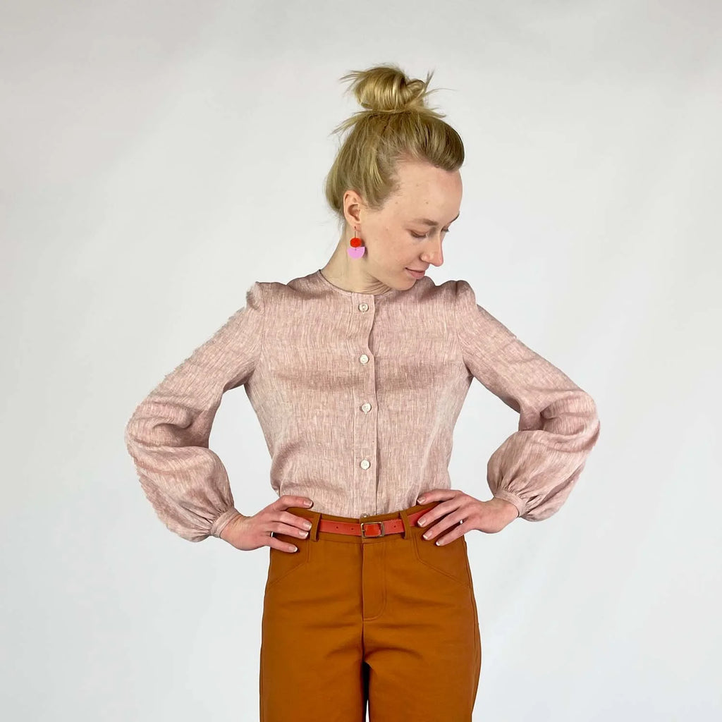Gable Shirt sewing pattern — model wearing a button-front blouse in blush linen with voluminous bishop sleeves, gathered cuffs, and collarless neckline, front view