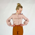 Gable Shirt sewing pattern — model wearing a button-front blouse in blush linen with voluminous bishop sleeves, gathered cuffs, and collarless neckline, front view