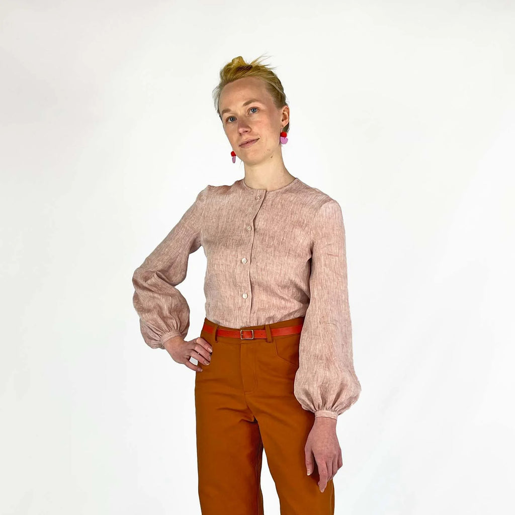 Gable Shirt sewing pattern — model wearing a button-front blouse in blush linen with voluminous bishop sleeves, gathered cuffs, and collarless neckline, front view
