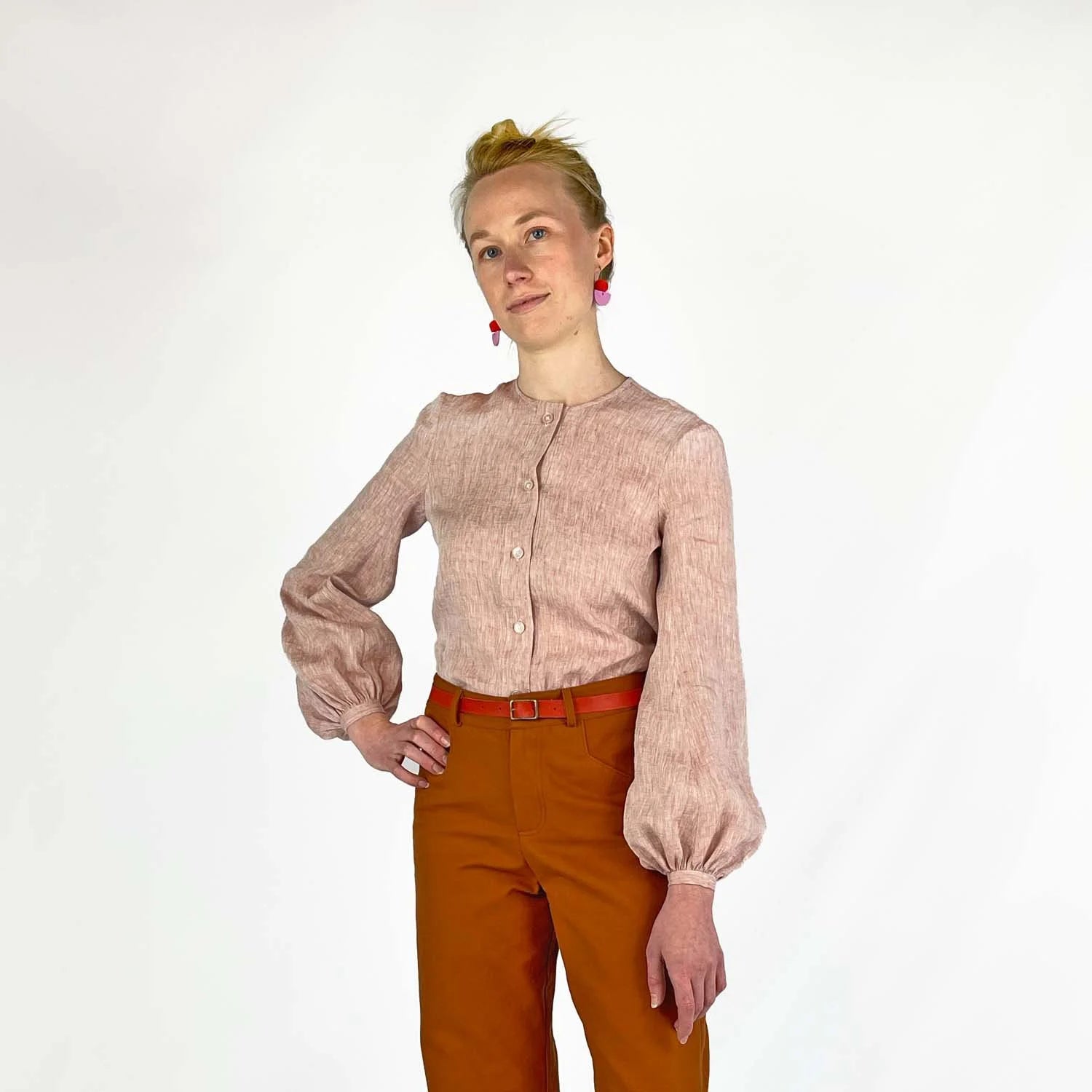 Gable Shirt sewing pattern — model wearing a button-front blouse in blush linen with voluminous bishop sleeves, gathered cuffs, and collarless neckline, front view