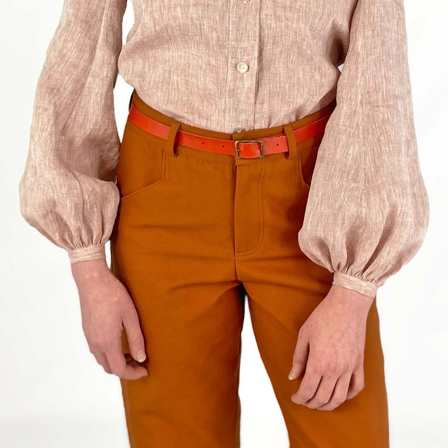 Gable Shirt sewing pattern — model wearing a button-front blouse in blush linen with voluminous bishop sleeves, gathered cuffs, and collarless neckline, write detail view