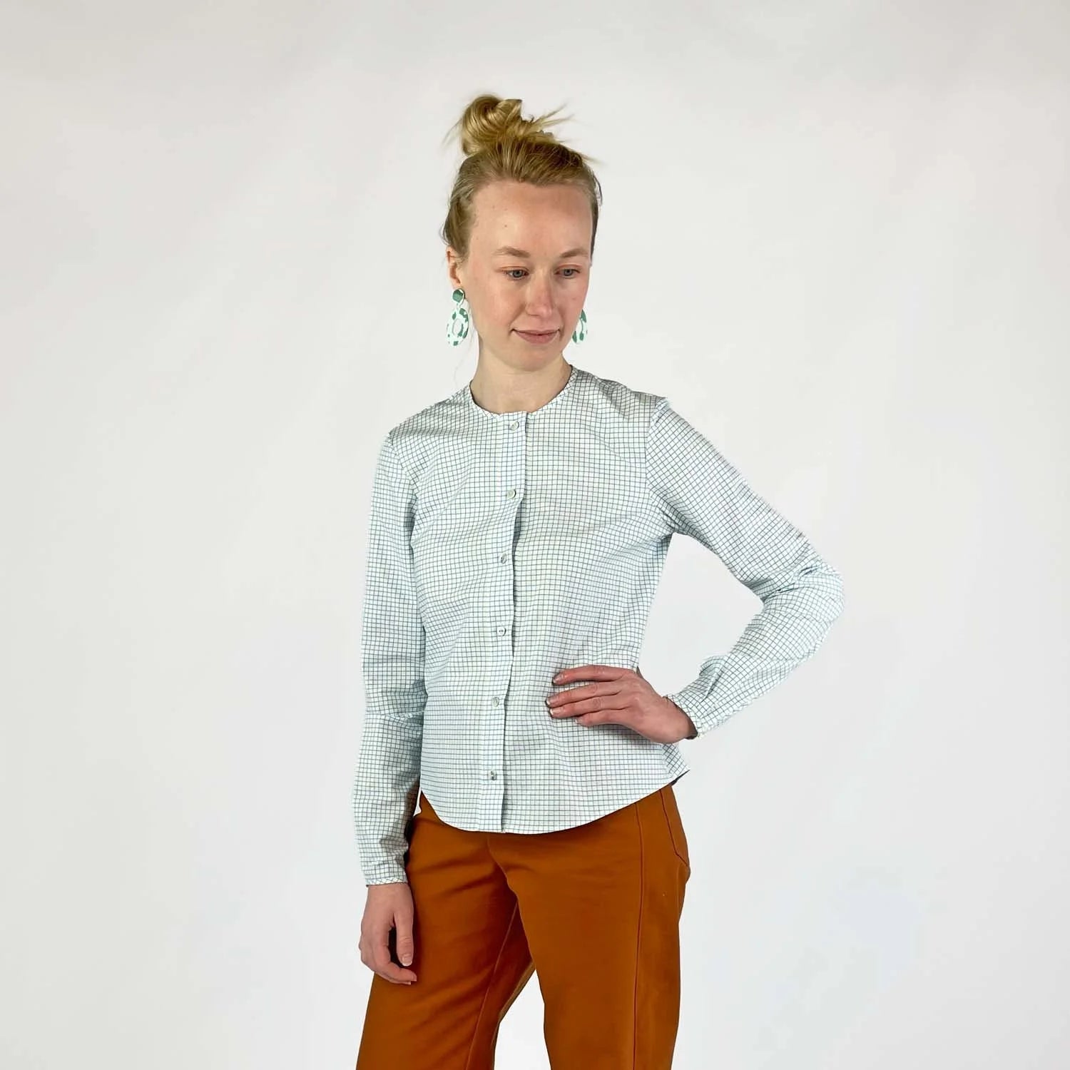 Gable Shirt sewing pattern — model wearing a button-front blouse in a grid paper patterned fabric with long sleeves sleeves and collarless neckline, front view