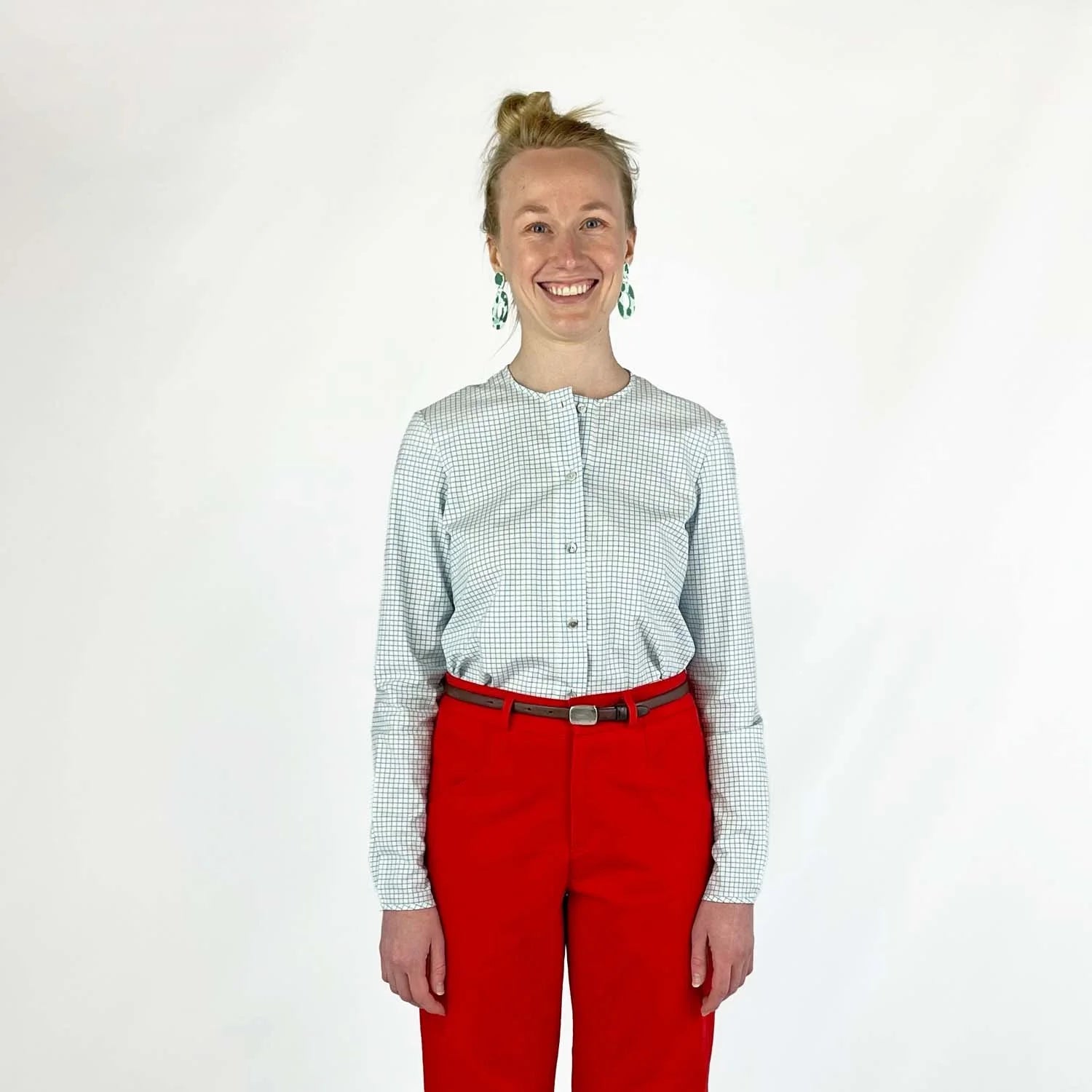 Gable Shirt sewing pattern — model wearing a button-front blouse in a grid paper patterned fabric with long sleeves sleeves and collarless neckline, front view