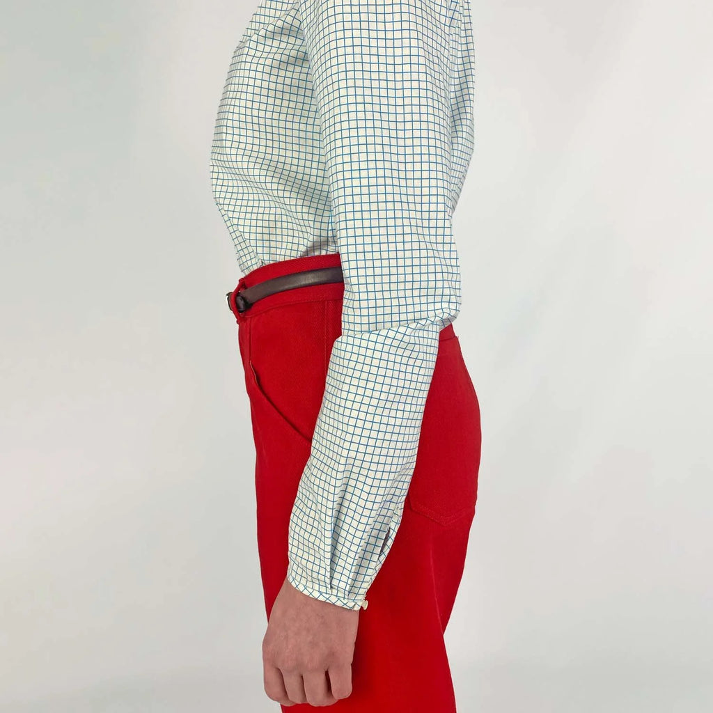 Gable Shirt sewing pattern — model wearing a button-front blouse in a grid paper patterned fabric with long sleeves sleeves and collarless neckline, sleeve view