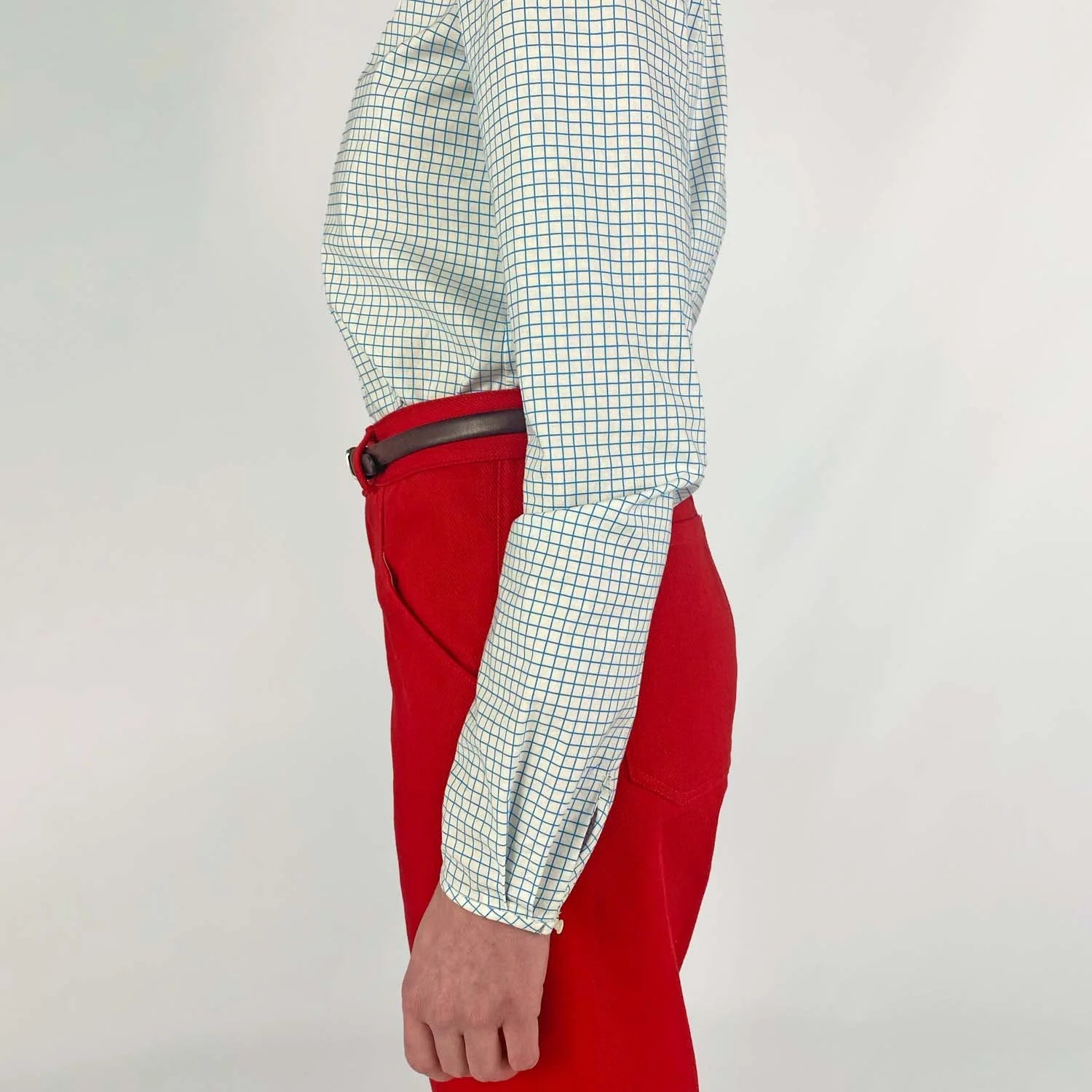 Gable Shirt sewing pattern — model wearing a button-front blouse in a grid paper patterned fabric with long sleeves sleeves and collarless neckline, sleeve view