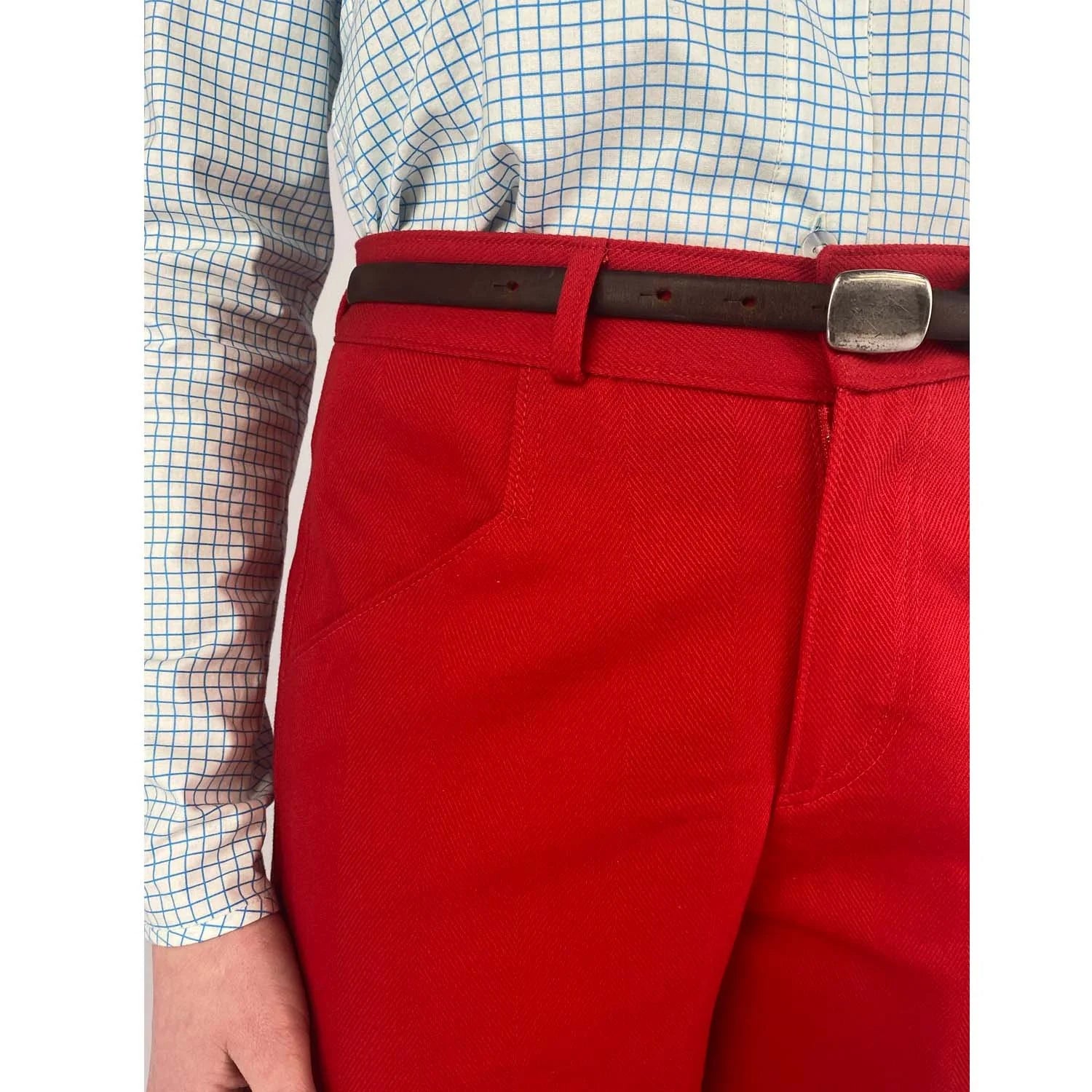 Shop Pant sewing pattern — model wearing high-waisted barrel leg pant in red herringbone twill with front pockets and belt, pocket view