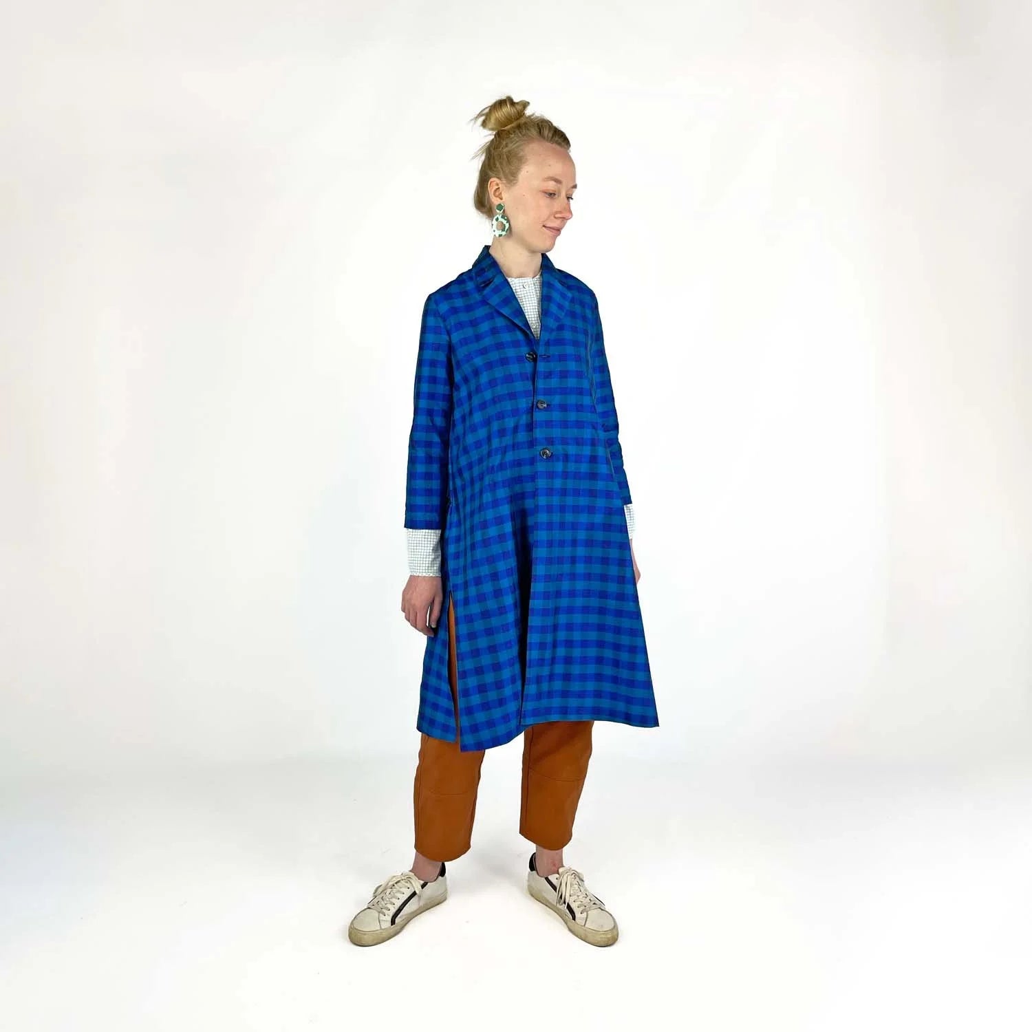 Swing Coat sewing pattern — model wearing an A-line swing coat in blue gingham with notched lapel, three-quarter sleeves, and gold buttons, side view
